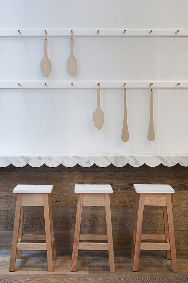 Interior Design for a Cupcake Shop white wall and chair with spoon