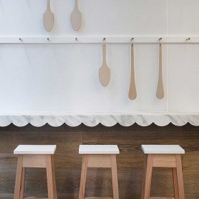 Interior Design for a Cupcake Shop white wall and chair with spoon
